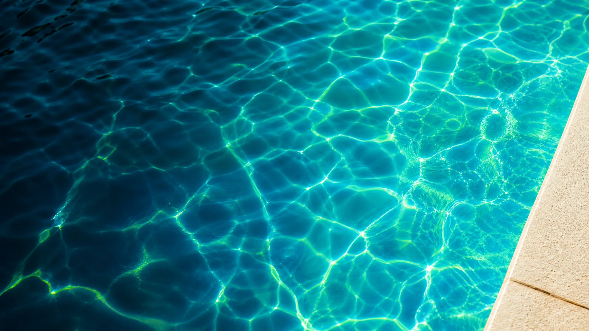 Illustrative turquoise pool water with sunlit ripples